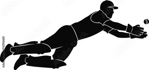 Silhouette of a cricket player diving to catch a ball