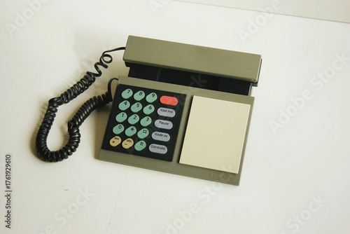 Grey phone with multi colored bottoms. Memphis style design from the 1980s. 