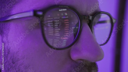 Excited young male stock market broker looking at graph on computer