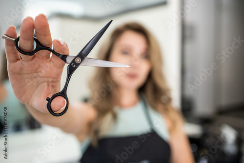 Woman holding scissors. Woman hairdresser