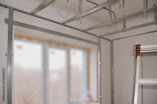 Drywall frame installation around window opening and on ceiling for renovation work