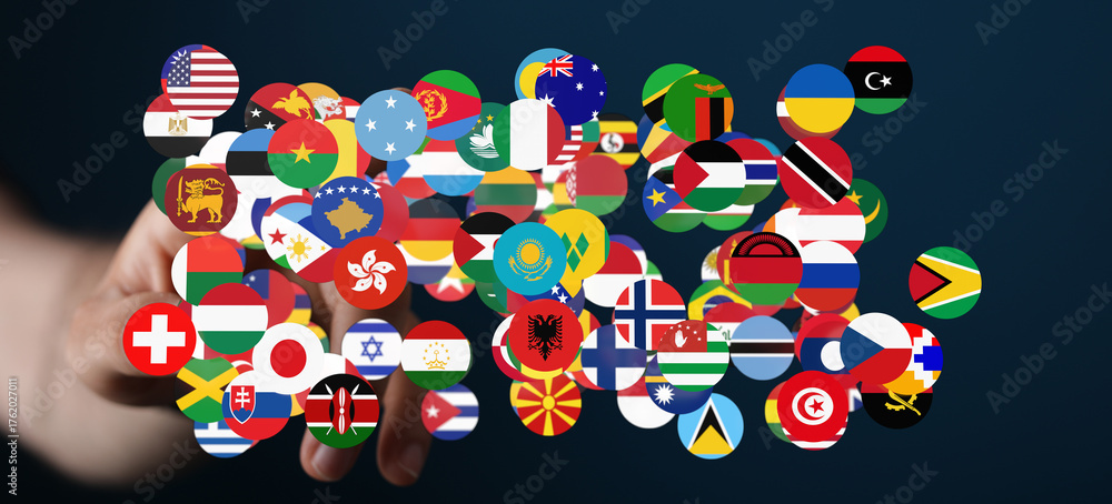Fototapeta premium A hand holding a cluster of international flags, symbolizing global unity, cooperation, and the concept of a connected world. Perfect for themes