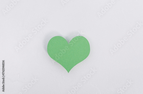 A green heart cutout is pla...