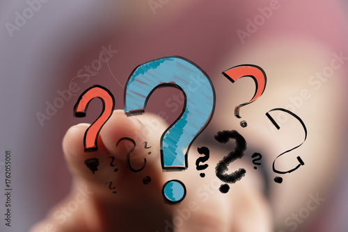 Hand pointing at question m...