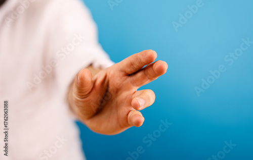 Close-up of a hand reaching...