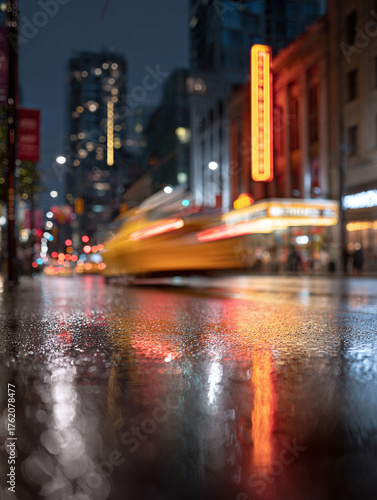 Urban abstract capturing the city at night. Rain slicked streets reflect vibrant neon lights and blurred motion, evoking energy  modern life. Great for backgrounds.