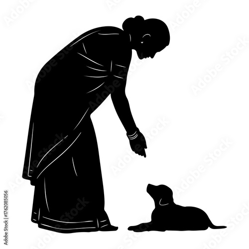 Woman training puppy silhouette sari