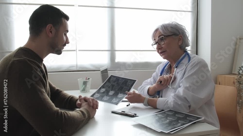 Doctor discussing mri scan with patient during medical consultation