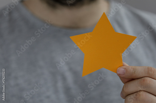 Person holding an orange st...