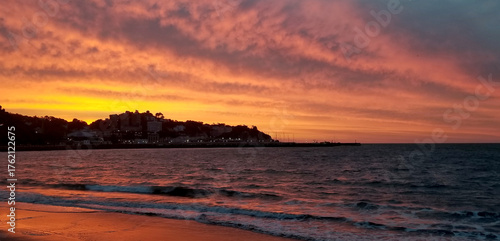 Torquay, Torbay, Devon, England: The early morning sun illuminates the morning cloudscape and reflects on the sands of Torre Abbey beach. Torbay is a popular UK holiday destination (Photo 3 of 11).