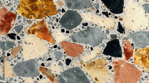 A close-up of a vibrant, textured surface featuring irregular-shaped, colorful stones embedded in a light-colored matrix