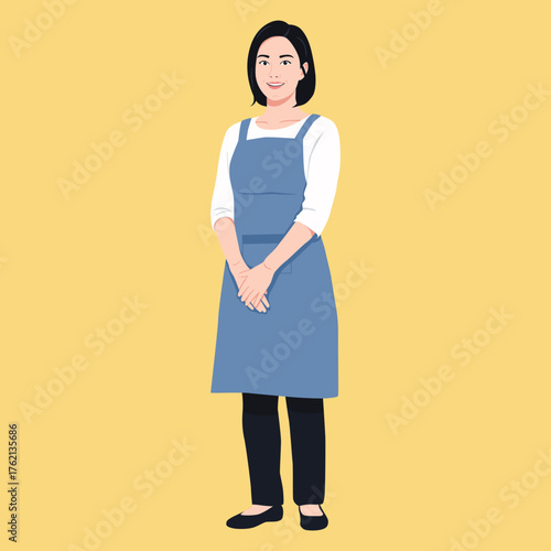 cheerful Asian woman with short dark hair wearing a blue apron over a white shirt and black pants. ready for service work.