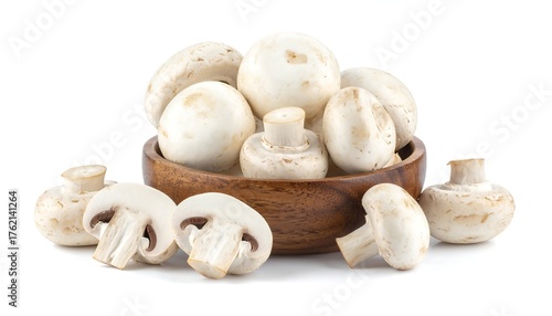 Close-up of white, fresh, whole and sliced fungi in a wooden bowl
