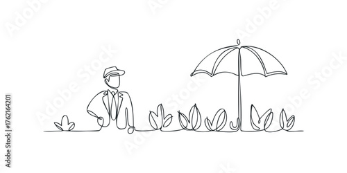 Man in Hat Standing Near Umbrella Over Plants