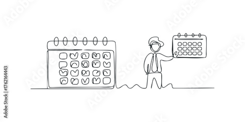 Man holding a calendar next to a large calendar