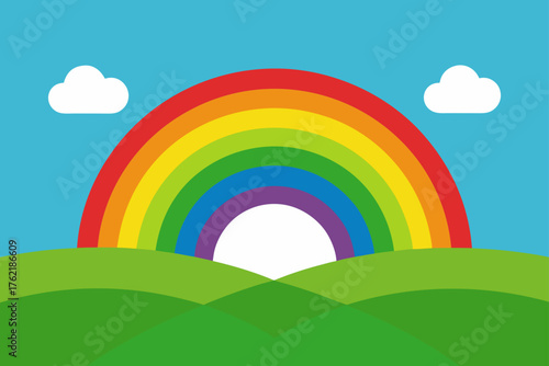 Bright rainbow arching over rolling green hills under blue sky