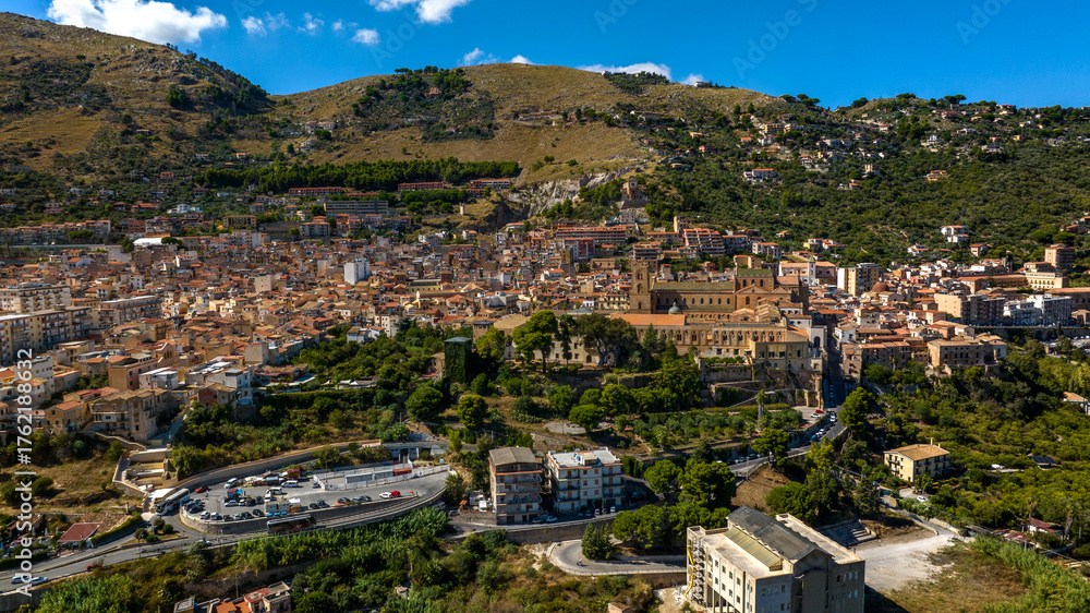 Obraz premium Aerial view of the town of Monreale, in the metropolitan city of Palermo, Sicily, Italy. It's a small town at the foot of a mountain. The cathedral in the historic center is a World Heritage Site.