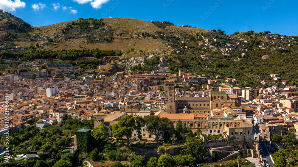 Obraz premium Aerial view of the town of Monreale, in the metropolitan city of Palermo, Sicily, Italy. It's a small town at the foot of a mountain. The cathedral in the historic center is a World Heritage Site.