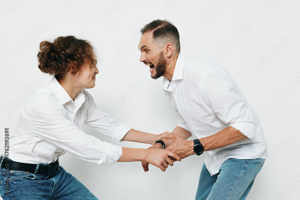 Obraz premium A professional business man and colleague share a dynamic moment against a clean colored background, expressing energy, teamwork, and motivation in a vivid workplace scene.