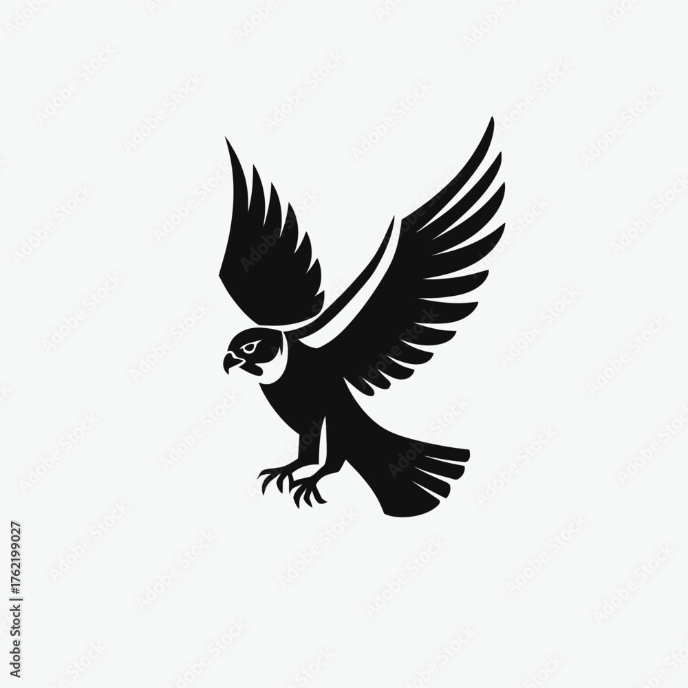 Obraz premium Dynamic black silhouette of a majestic bird of prey in flight with wings spread, symbolizing power, freedom, and strength.