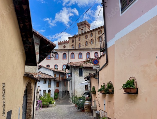 A charming street scene in Barolo, Italy, featuring the historic Castello Falletti di Barolo in the background. Piedmont, Italy.
