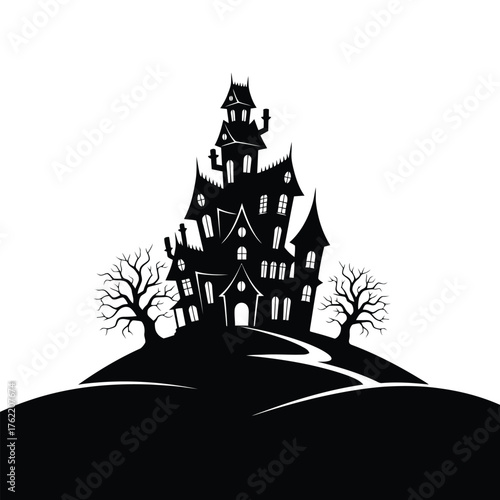 Silhouette of a haunted house on a hill with bare trees
