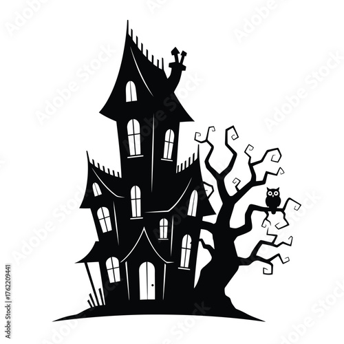Silhouette of a haunted house next to a spooky bare tree