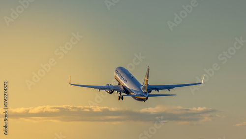 Ryanair airplane taking off into a golden sunset sky, symbolizing travel, freedom, and adventure