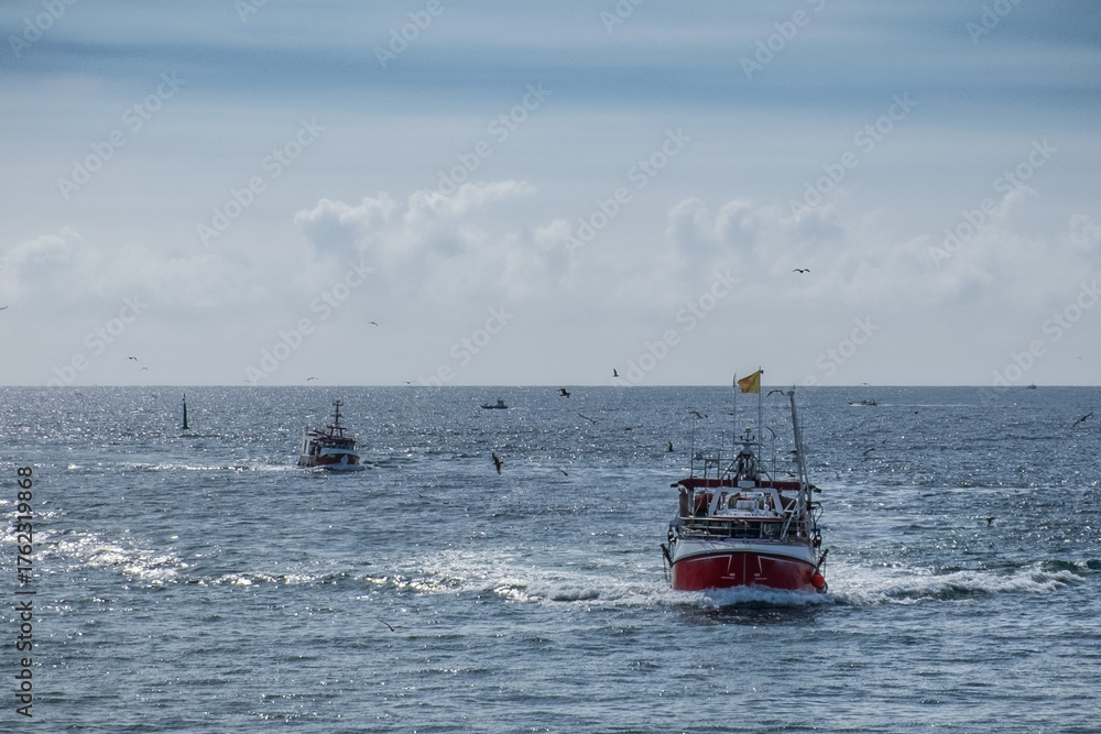 Naklejka premium Fish boat sailing back to the harbor in Atlantic ocean, Bretagne France