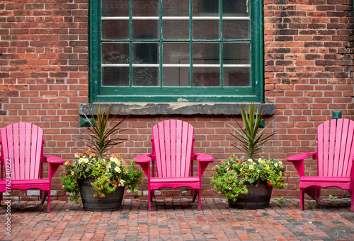 window with pink Muskoka chair and flowers