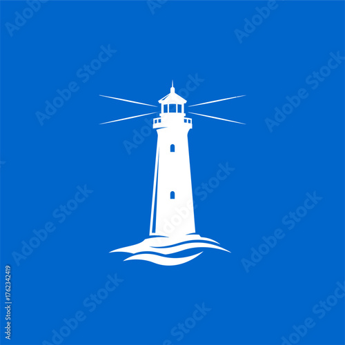  A towering lighthouse beacon stands against the blue sky and ocean for nautical navigation