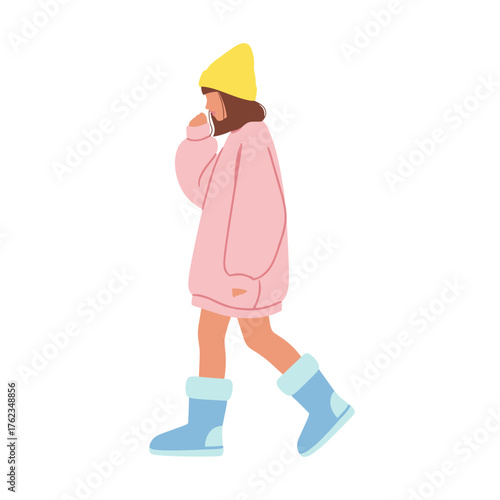 Young woman walking and thinking while wearing winter clothes