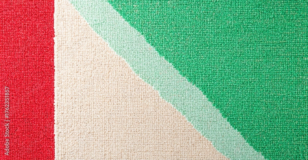 Fototapeta premium Rectangular textile displays red, white, green colors. Diagonal stripe divides fabric into sections. Texture appears woven, possibly canvas material.