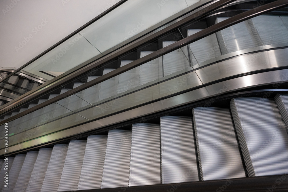Obraz premium Modern Escalators and Elevators in a Contemporary Building Interior