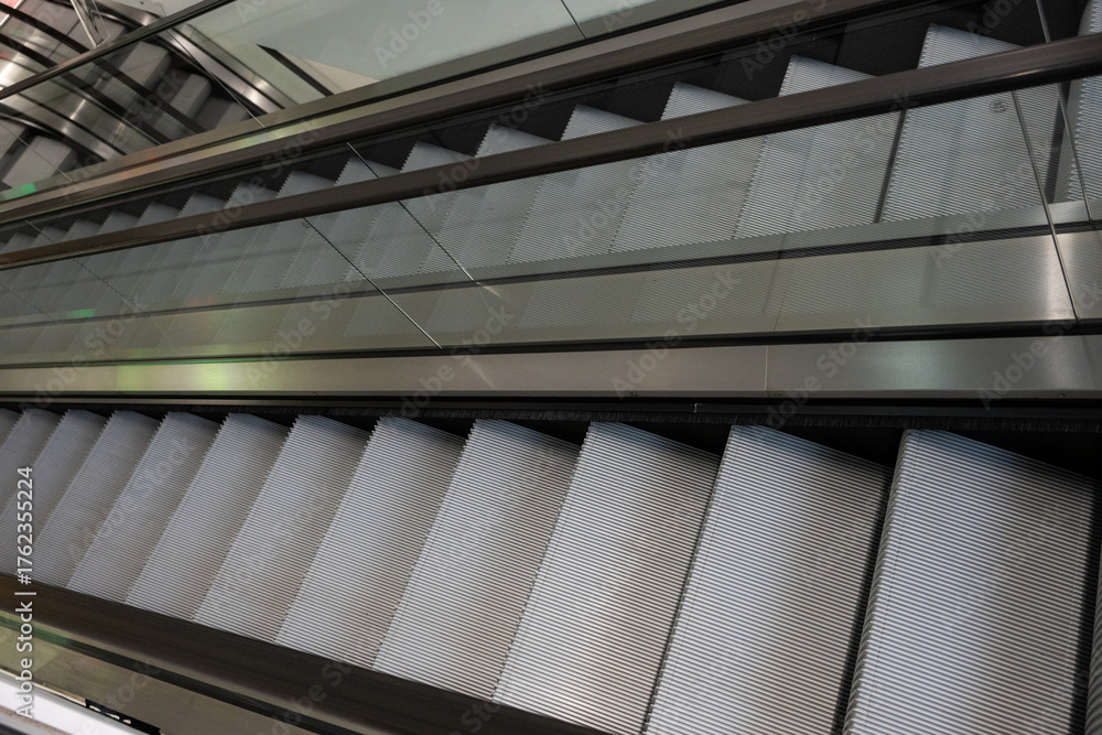 Obraz premium Modern Escalators and Elevators in a Contemporary Building Interior