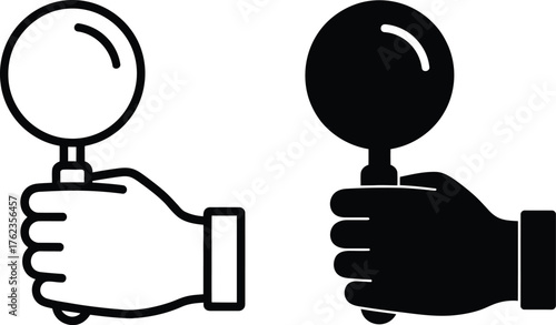 Two magnifying glasses held in hands black and white a strong silhouette.
