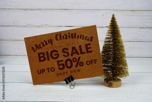 Festive display with small decorative Christmas trees with "Special Offer Merry Christmas Big Sale up to 50% off, Promotion Holiday Sale Event