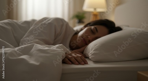 Woman sleeping comfortably in bed at home