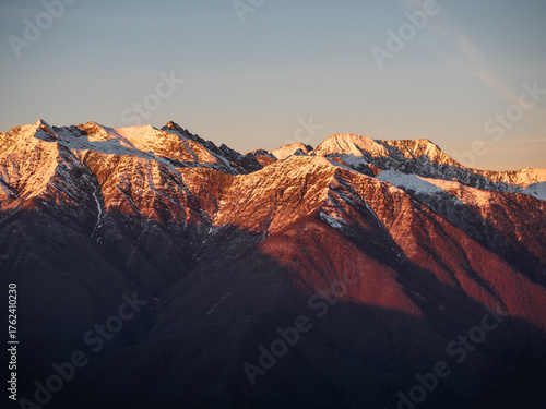 Winter mountain landscape, snowy peaks on sunset
