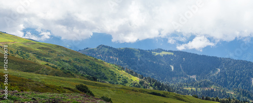 view of the Caucasus Mountains in the clouds in summer - panorama