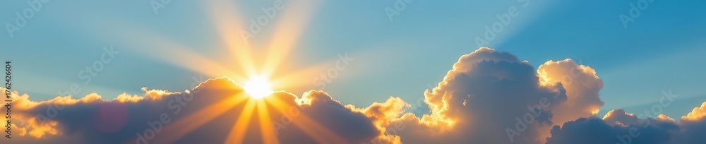 Fototapeta premium Golden sunlight pierces soft, white clouds against a vibrant, clear blue sky, radiance, daylight