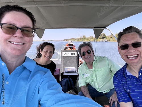 Friends enjoying a sunny boat ride on the river