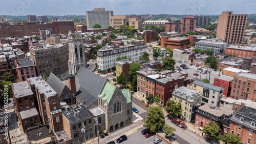 Morning sun shines on church and building architecture in the heart of the historic Mount Vernon neighborhood of Baltimore, Maryland, USA.