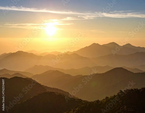 Wallpaper Mural Golden Sunset Over Mountain Ridges with Hazy Atmosphere and Warm Lighting Torontodigital.ca