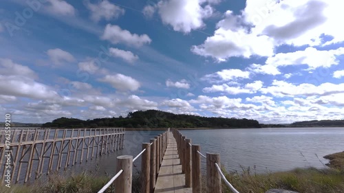 wooden pier over lagoon cloudy day 