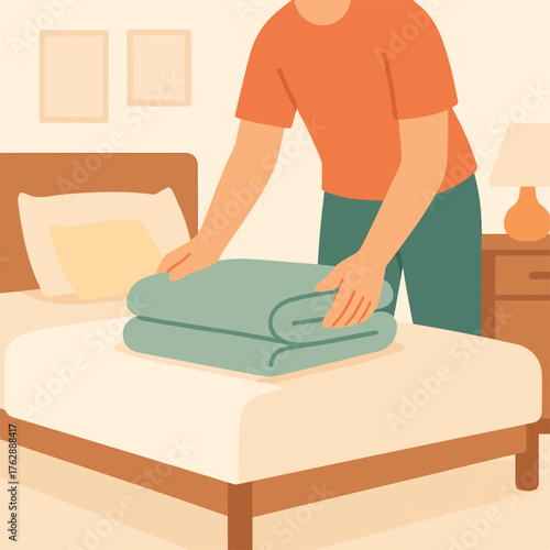 Person folding blanket on bed in bedroom