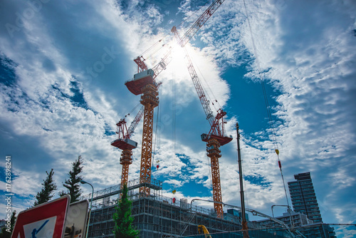 A cityscape of moving crane and cloud at the under construction wide shot