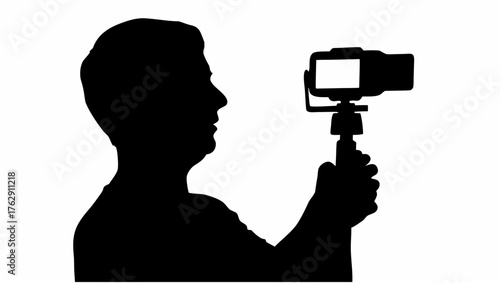 Silhouette of a person holding a camera on a stick with a white screen facing forward in a studio setting