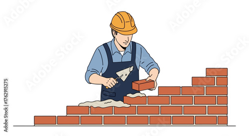 A worker wearing a yellow hard hat builds a brick wall adding mortar and bricks