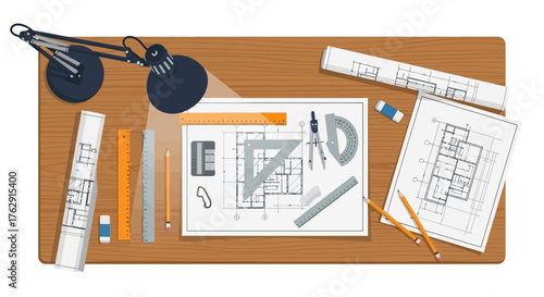 Architects desk with blueprints tools and lamp